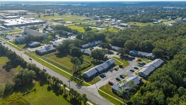 an aerial view of residential houses with outdoor space