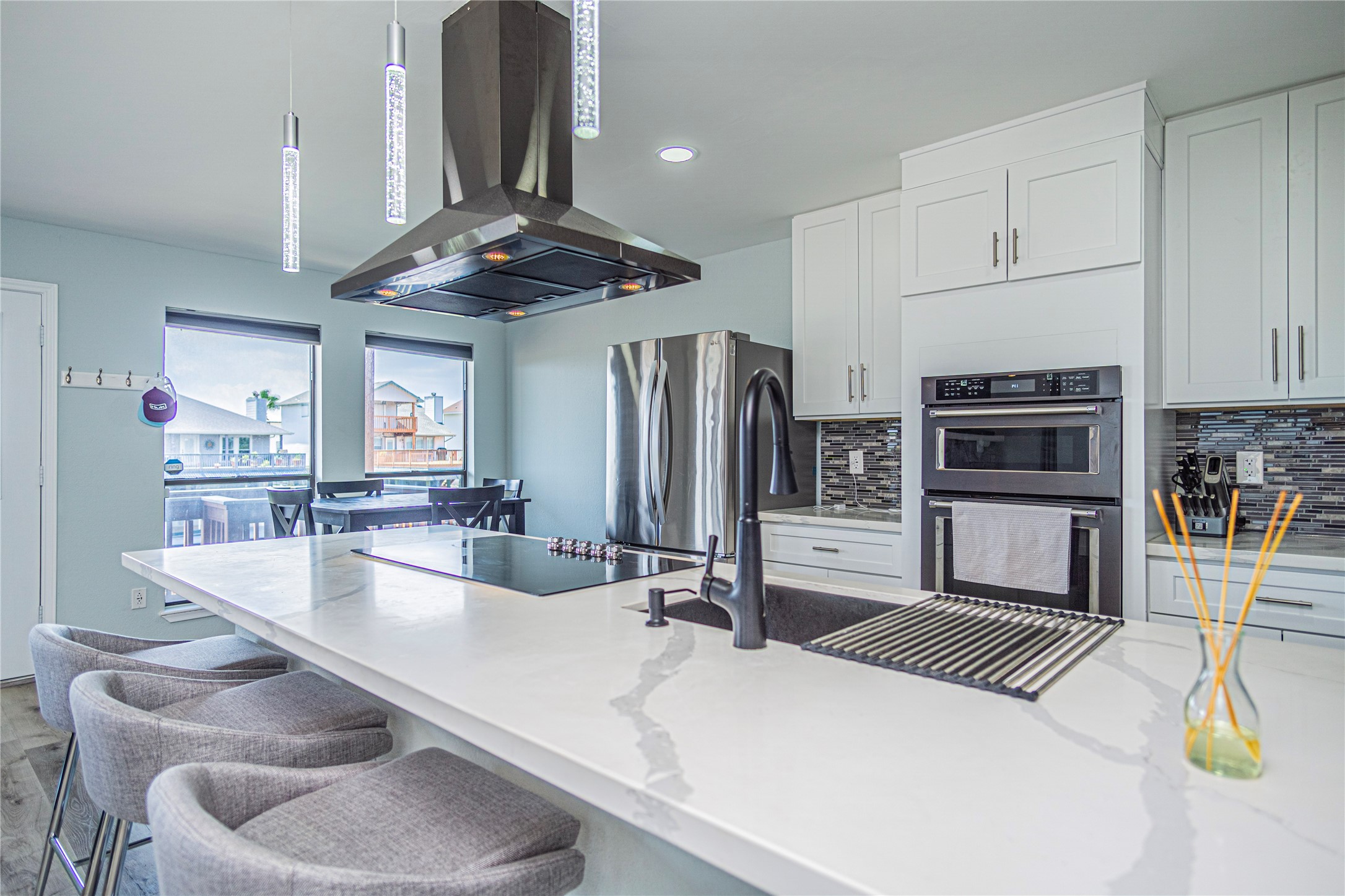 301 Commander Drive Tiki Island, TX 77554 - Photo 13 of 35 a kitchen with stainless steel appliances a dining table and chairs