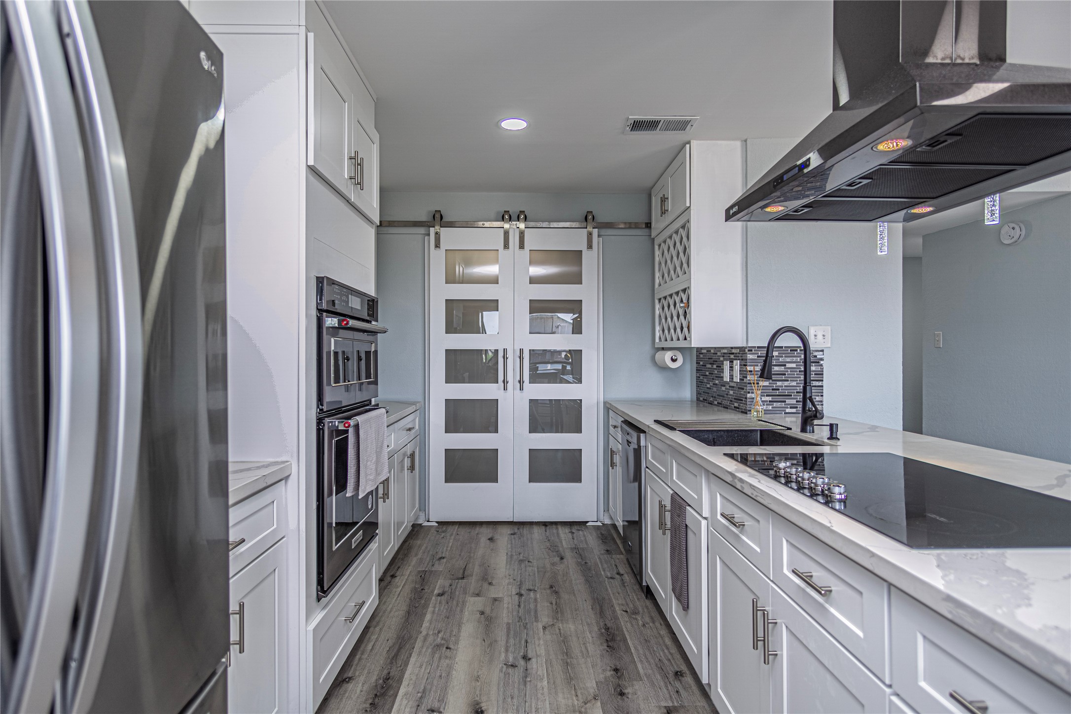 301 Commander Drive Tiki Island, TX 77554 - Photo 15 of 35 a kitchen with a refrigerator and a sink