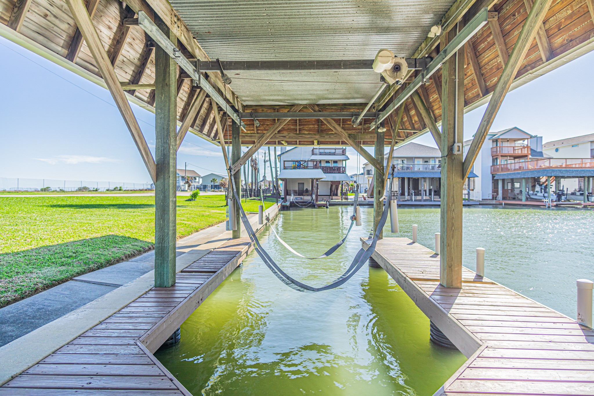 301 Commander Drive Tiki Island, TX 77554 - Photo 3 of 35 a view of a swimming pool with a patio and a garden