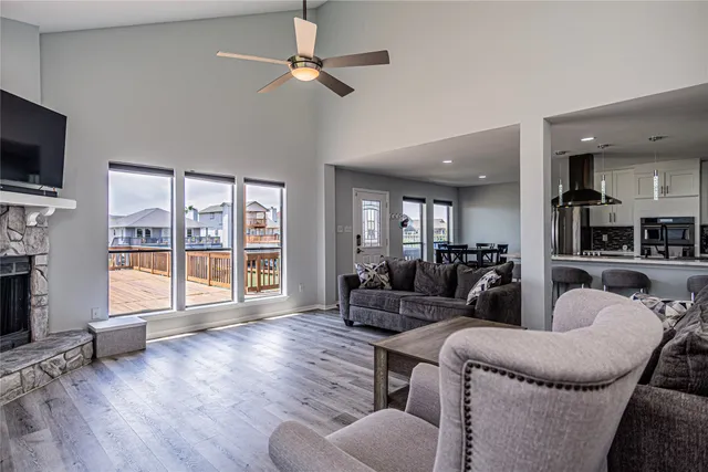 a living room with furniture a flat screen tv and a large window