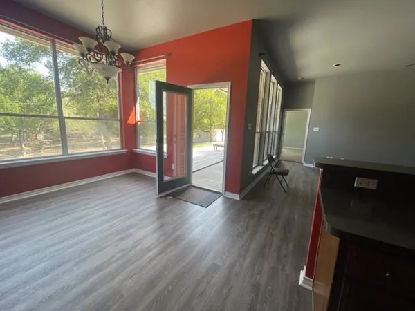a view of livingroom with furniture wooden floor and a floor to ceiling window