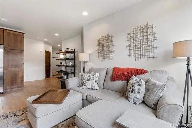 a living room with furniture and a book shelf
