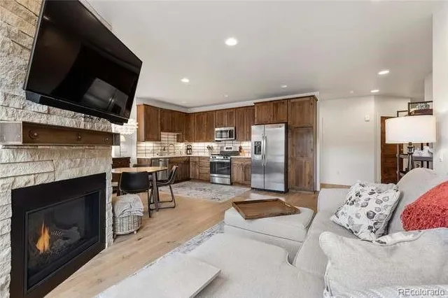 a living room with furniture a fireplace and a flat screen tv