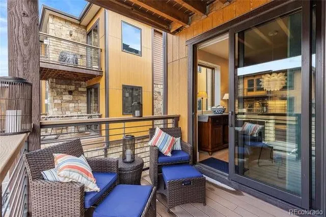 a kitchen with stainless steel appliances a dining table chairs stove refrigerator and microwave