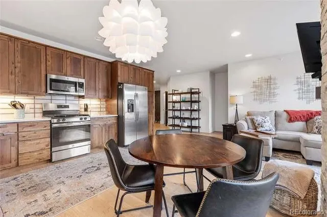 an empty room with wooden floor and book shelf
