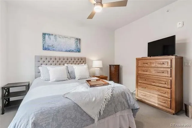 a bedroom with a bed and a television