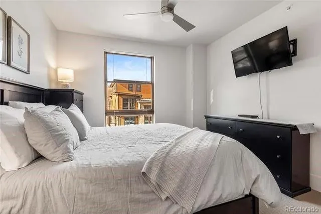 a bedroom with a bed and a painting