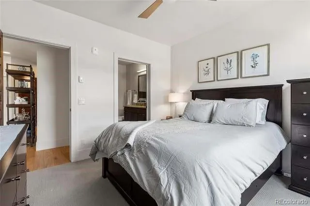 a bathroom with a granite countertop sink a toilet a mirror and shower