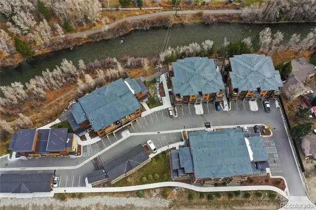 a view of a hallway with wooden floor and a potted plant
