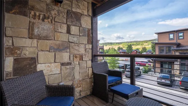 a kitchen with stainless steel appliances granite countertop a stove a sink dishwasher a dining table and chairs with wooden floor