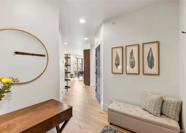 a living room with furniture and a mirror