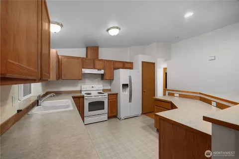 a kitchen that has a sink and a stove