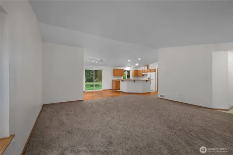 a view of a kitchen with a sink and a refrigerator