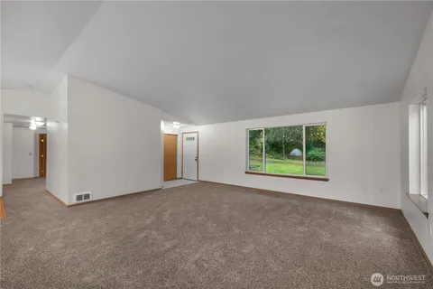 an empty room with windows and closet