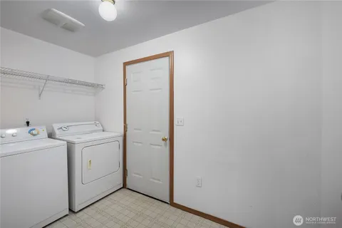 a view of a storage & utility room with dryer and washer