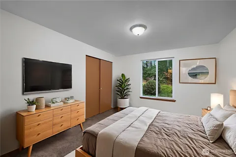 a bedroom with furniture and flat screen tv