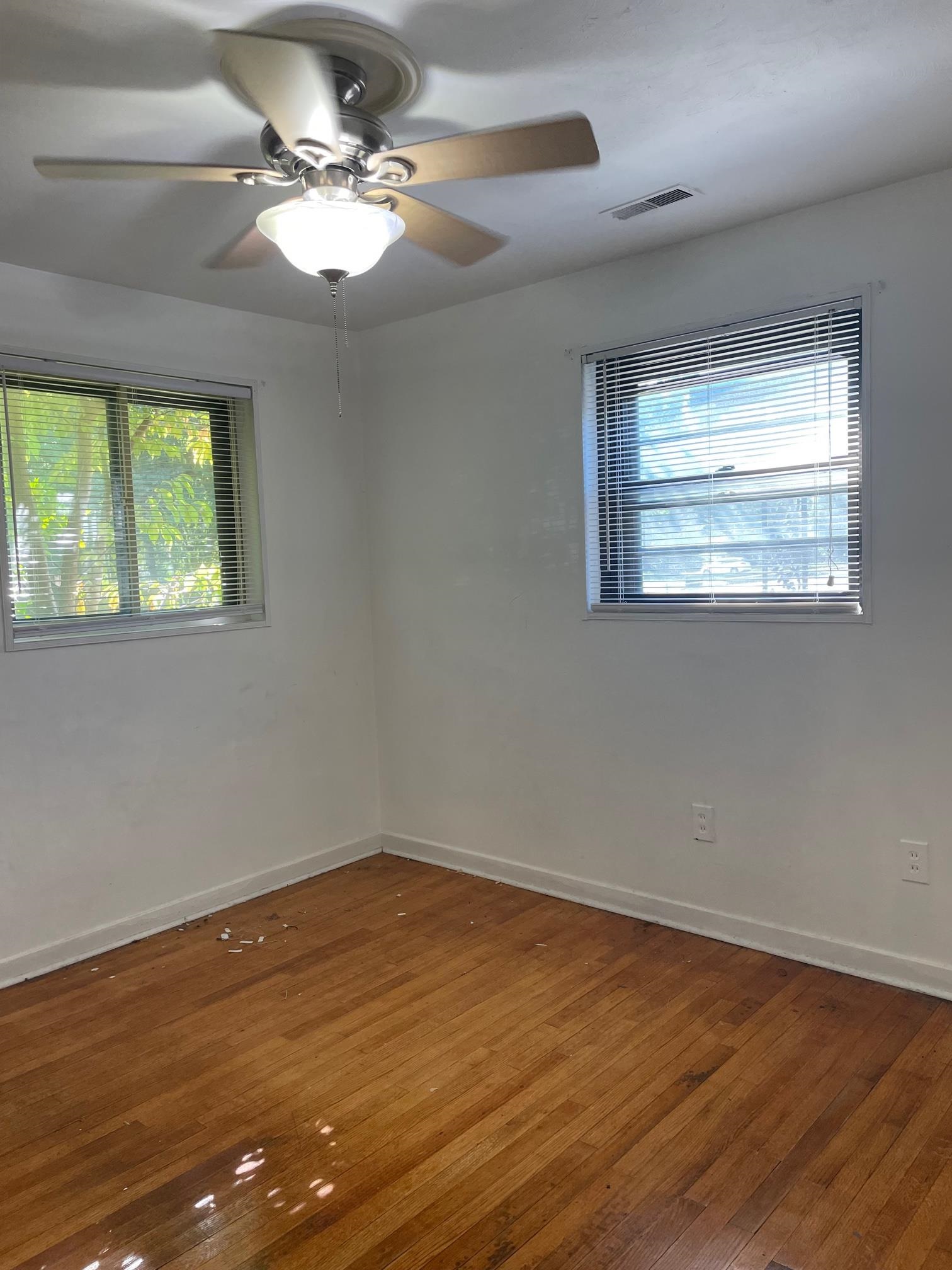 253 Montelo Road Memphis, TN 38120 - Photo 10 of 13 a view of a room with wooden floor and ceiling fan