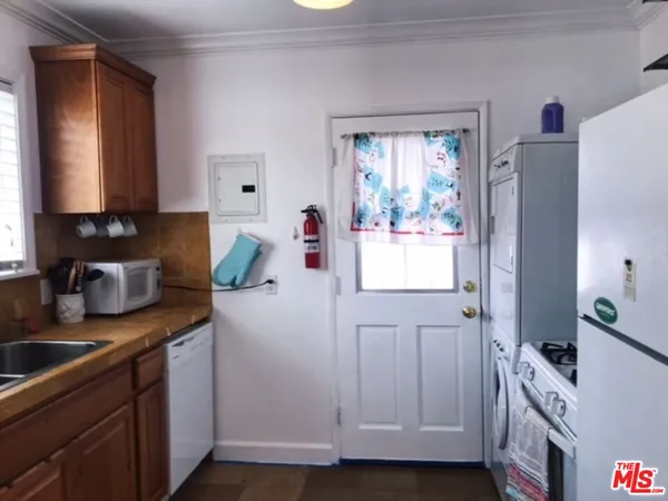 a kitchen with cabinets appliances and a window