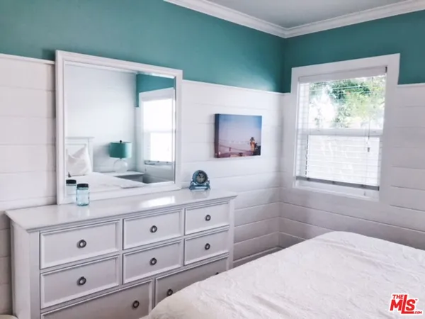 a bedroom with a bed and a dresser