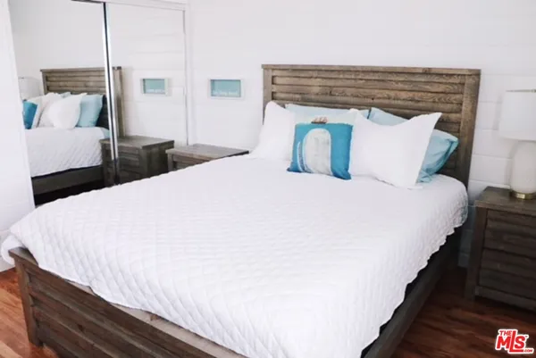 a large bed sitting in a bedroom and table