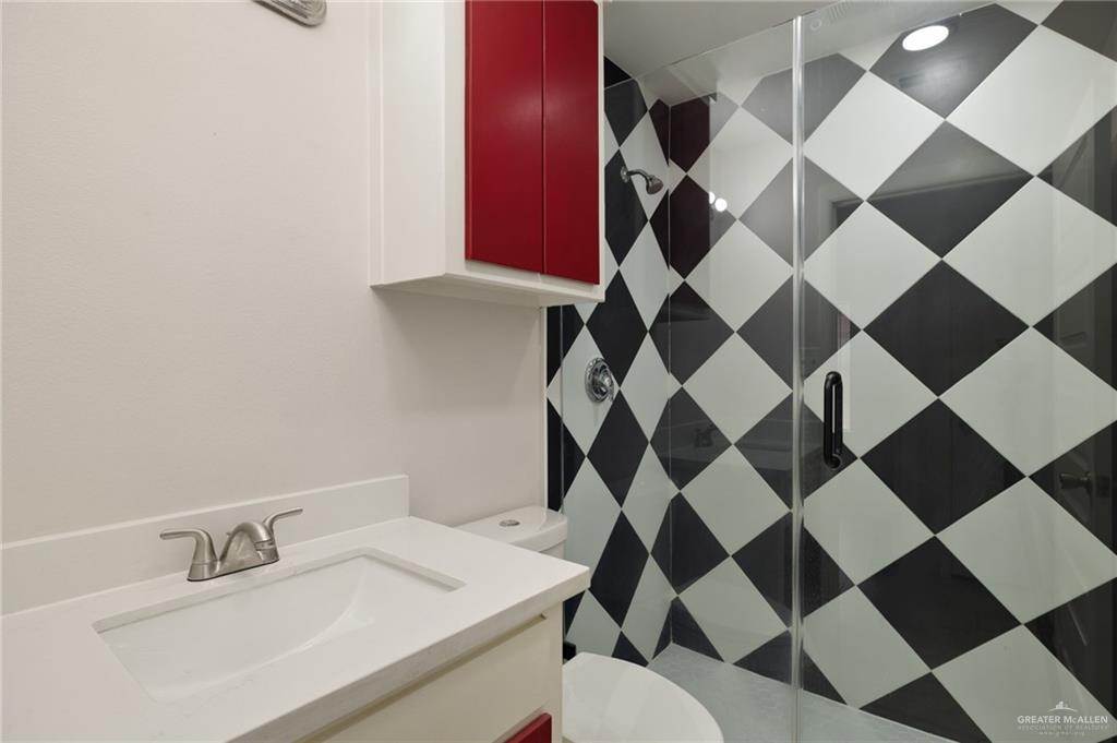 1913 South 35th Street McAllen, TX 78503 - Photo 11 of 12 a bathroom with a sink a toilet and a mirror