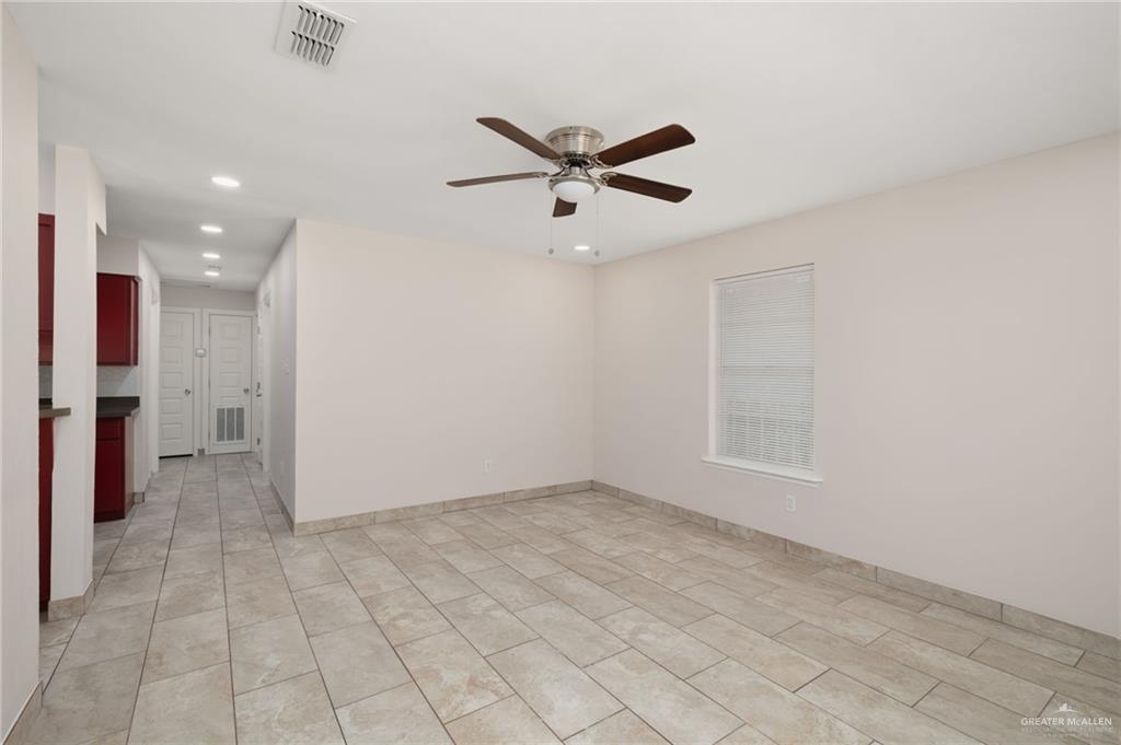 1913 South 35th Street McAllen, TX 78503 - Photo 3 of 12 an empty room with a ceiling fan and window