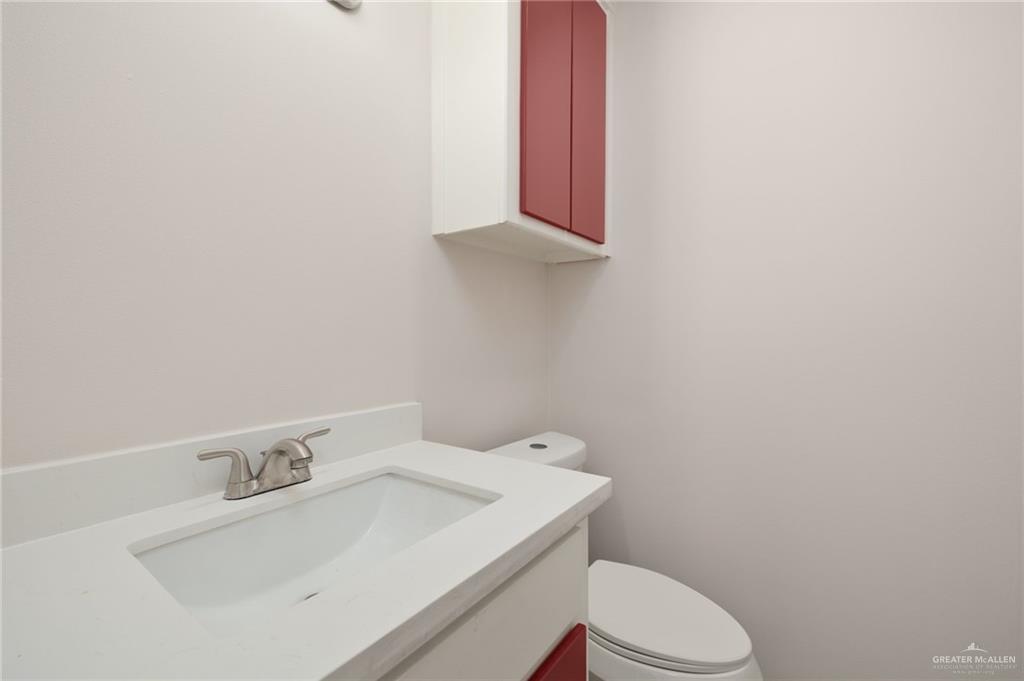 1913 South 35th Street McAllen, TX 78503 - Photo 9 of 12 a bathroom with a sink a toilet and mirror