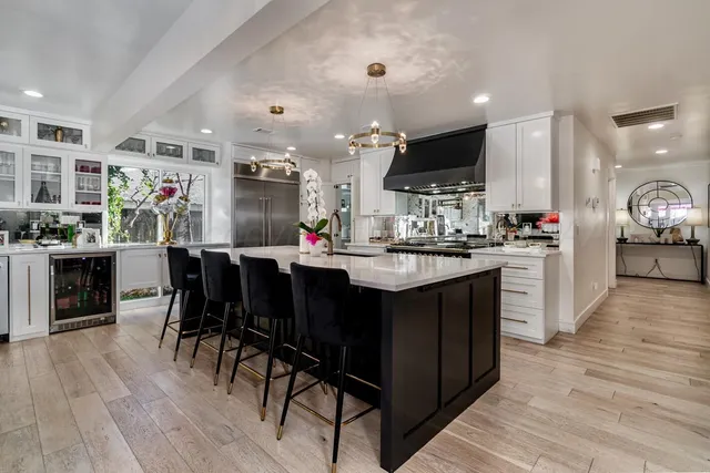 a kitchen with stainless steel appliances granite countertop a stove and a refrigerator