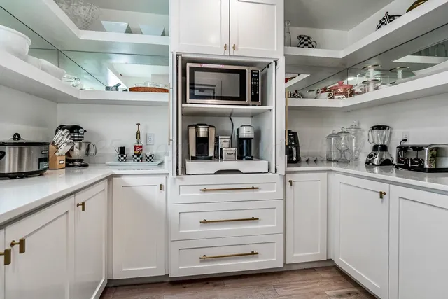 a kitchen with stove and cabinets