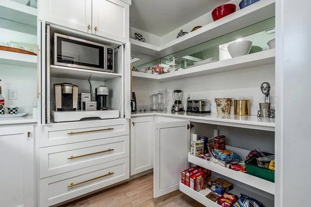 a kitchen with cabinets appliances and a sink