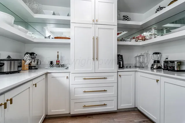 an outdoor space with lots of furniture and potted plants