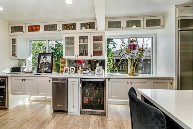 a kitchen with kitchen island granite countertop lots of counter top space and stainless steel appliances