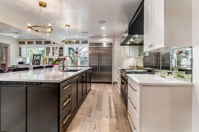 a kitchen with granite countertop a stove and refrigerator