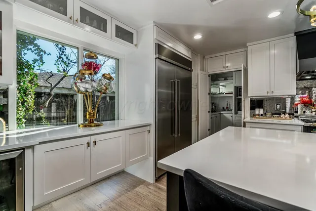 a bedroom with furniture and a large window