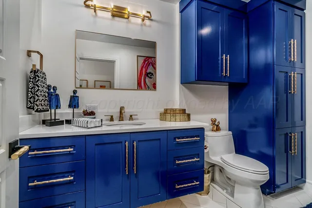 a bedroom with double bed and a painting on the wall