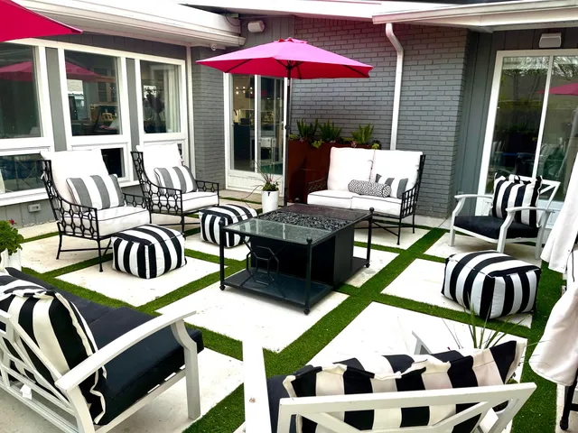 a view of a patio with table and chairs