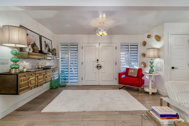 a spacious bathroom with stainless steel appliances kitchen island granite countertop a refrigerator and a stove