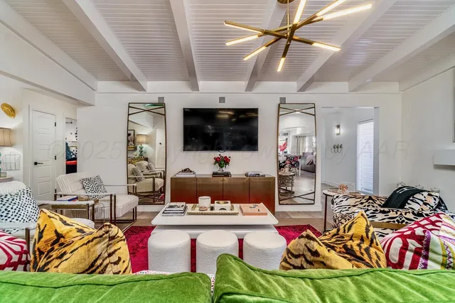 a living room with furniture and a chandelier