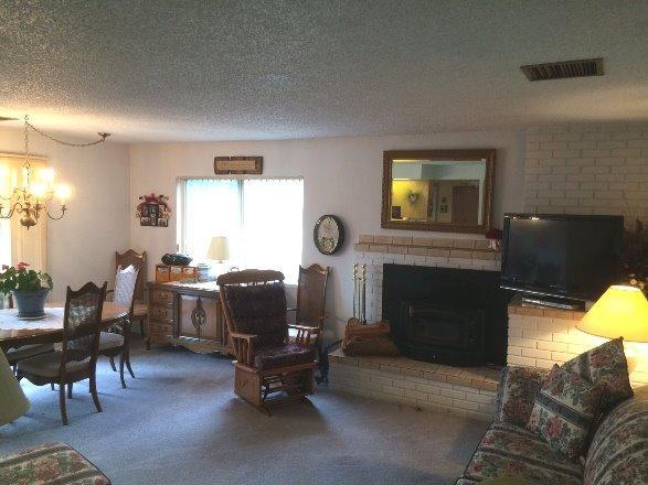 8251 North Applegate Road Grants Pass, OR 97527 - Photo 6 of 35 a living room with furniture a window and a fireplace