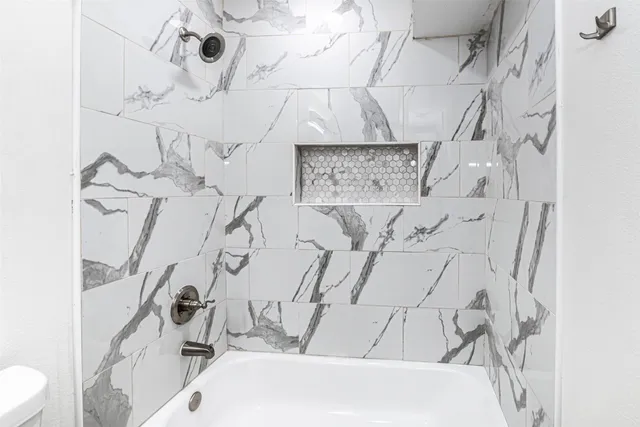 a bathroom with a bathtub and shower