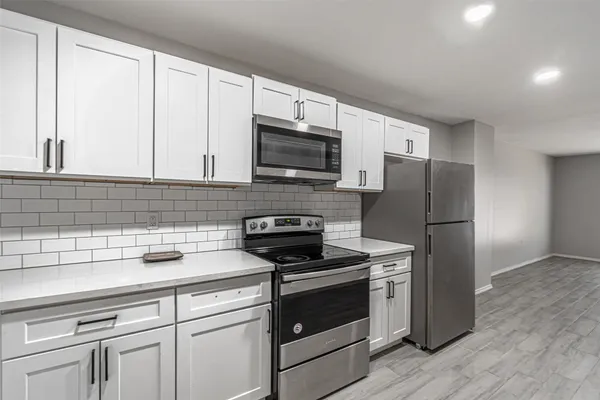 a kitchen with a refrigerator stove and microwave