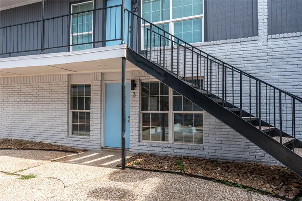 a view of a white house with a street
