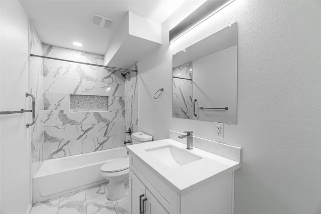 a bathroom with a sink toilet and shower