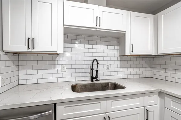 a kitchen with a sink cabinets and a window