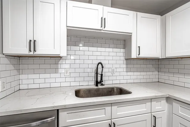 a kitchen with a sink cabinets and a window