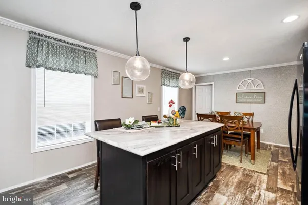 a kitchen with a counter space appliances and a chandelier
