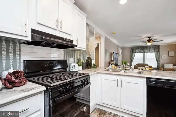a kitchen with a stove and a wooden floors