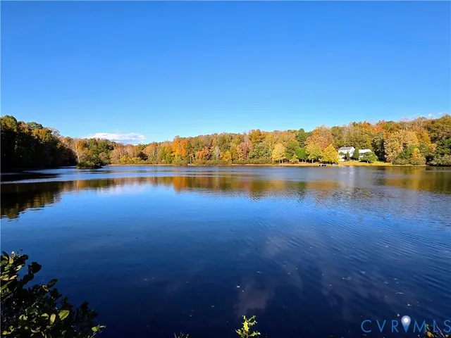 a view of a lake with houses in the back