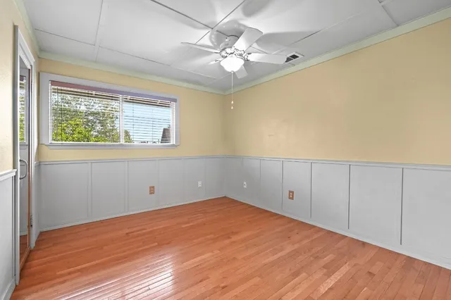 a view of an empty room with wooden floor